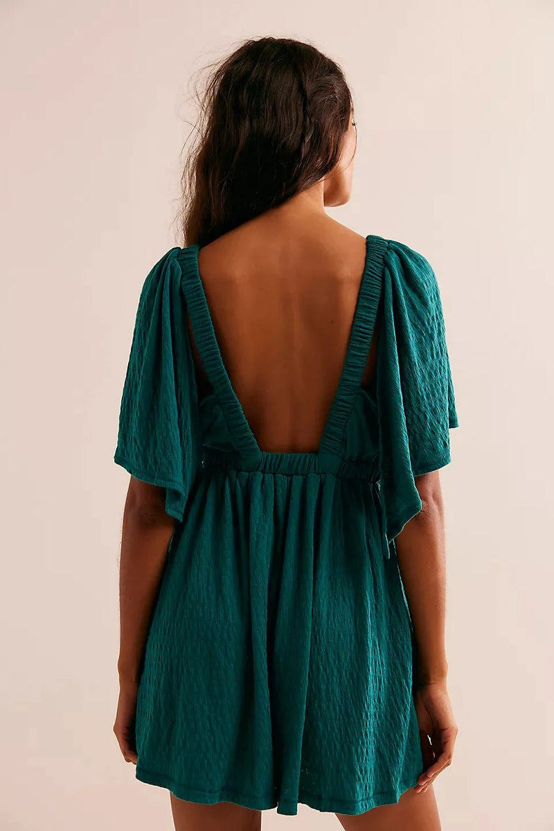 Bohemian Flare Jumpsuit: Deep V-Neck Open Back Romper with Flowy Silhouette for Women