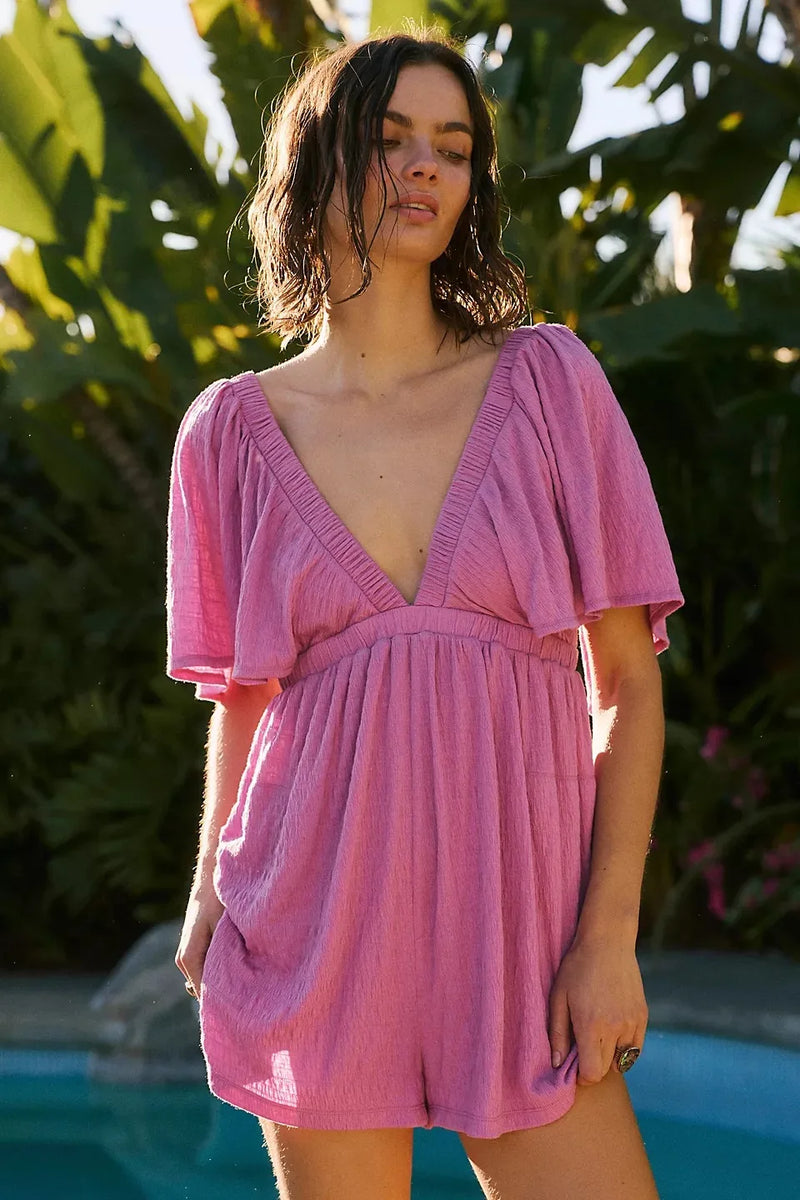 Bohemian Flare Jumpsuit: Deep V-Neck Open Back Romper with Flowy Silhouette for Women