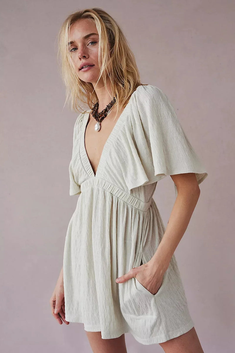 Bohemian Flare Jumpsuit: Deep V-Neck Open Back Romper with Flowy Silhouette for Women