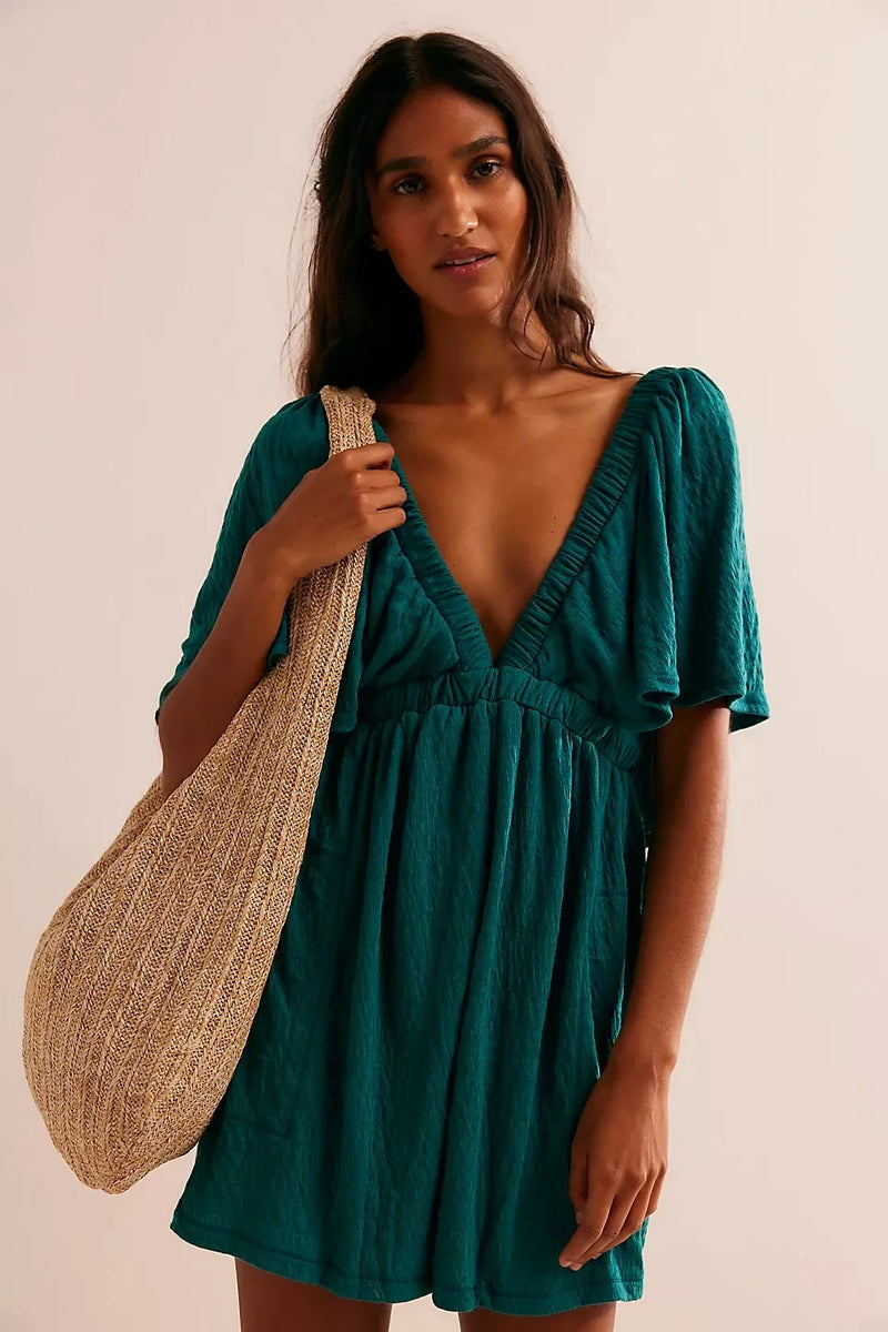 Bohemian Flare Jumpsuit: Deep V-Neck Open Back Romper with Flowy Silhouette for Women